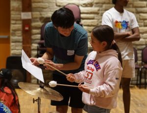 Music Mentor instructing a participant at Music Camp