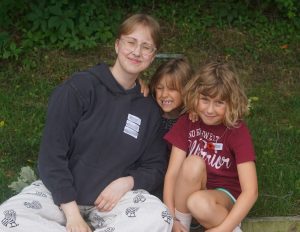 Music Mentor posing for a picture with campers at Band Camp