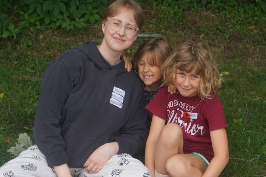 Music Mentor posing for a picture with campers at Band Camp