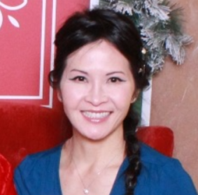 Ellen Chin smiling cheerfully and wearing a side braid